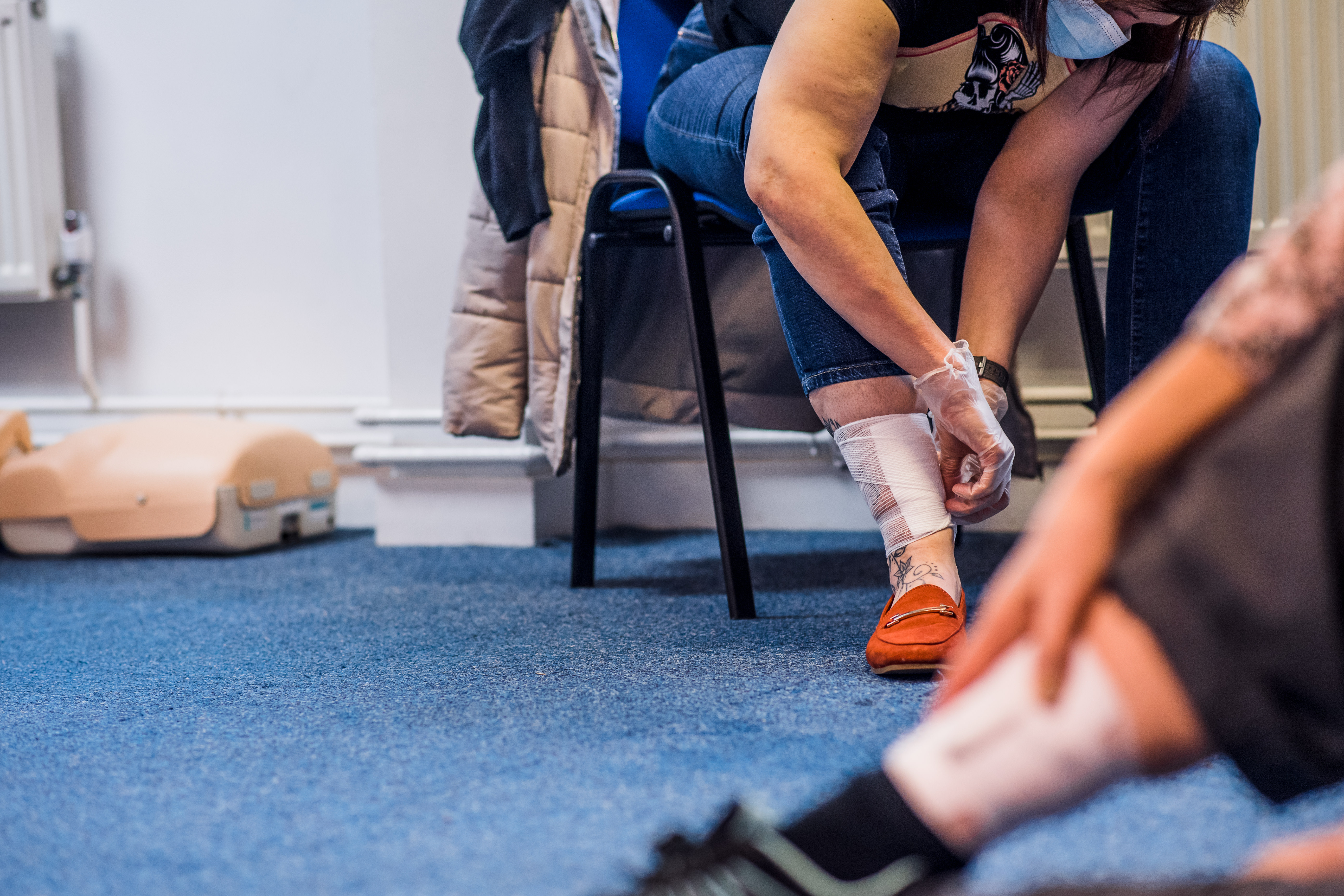 a woman using a bandage from a first aid kit